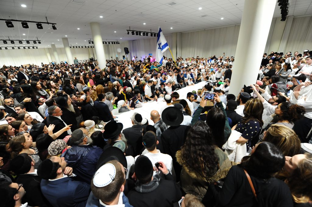 Thousands of Israelis attend the wedding party of Sarah Litman and Ariel Biegel, at the Jerusalem International Convention Center, November 26, 2015. Rabbi Yaakov Litman and Netanel Litman, Sarah Litman's father and brother, were murdered by a Palestinian terrorists two weeks before on November 14, 2015, as they made their way to the pre-wedding Shabbat Chatan celebration. The young couple decided to invite all of the people of Israel to celebrate their marriage. Photo by Mendy Hechtman/Flash90 *** Local Caption *** çúåðä ôéâåò èøåø áðééðé äàåîä úçéä ìéèîï àøéàì áéâì ùîçä